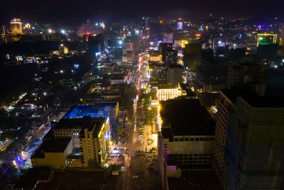 High angle view of illuminated buildings in city at night