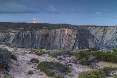 Scenic view of rocks on land against sky