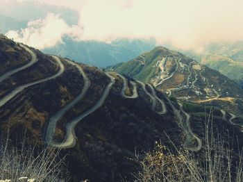 Scenic view of mountains against cloudy sky