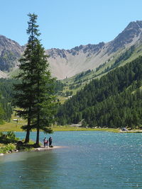 Scenic view of lake and mountains against clear sky