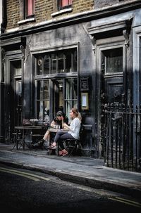 People sitting outside building