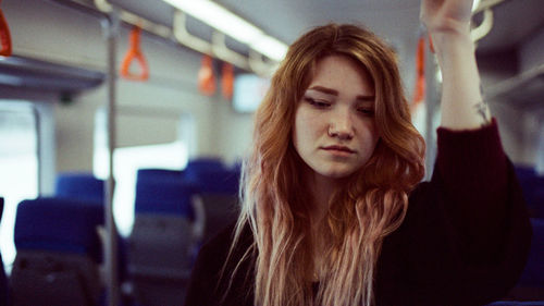 Portrait of a woman standing in a subway