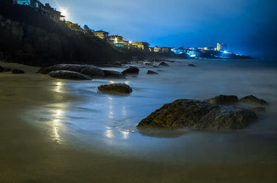 Scenic view of sea shore at night