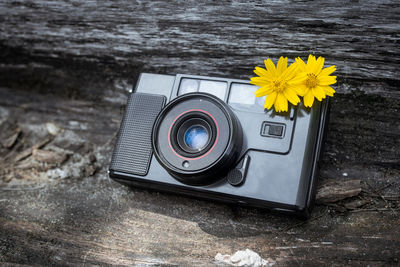 Close-up of yellow camera on plant