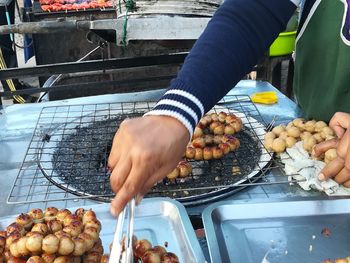 Man preparing food on barbecue grill
