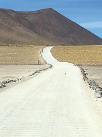 Surface level of empty road against rocky mountains