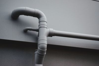 Low angle view of pipes on wall