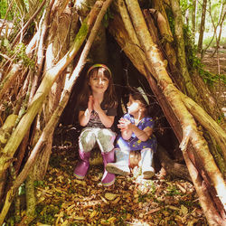 Happy girls in an autumn forest den