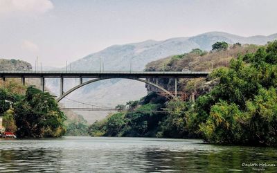 Bridge over river against sky