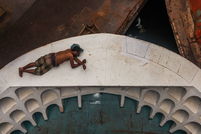 High angle view of man sleeping on boat