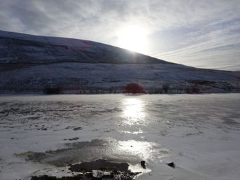 Scenic view of sea against cloudy sky
