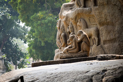 Low angle view of statue against trees