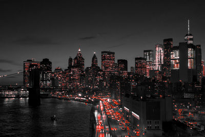 Illuminated buildings in city against sky at night