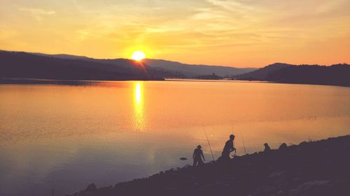 Scenic view of lake against sky during sunset