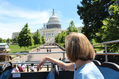 Woman on bus in front of capitol building