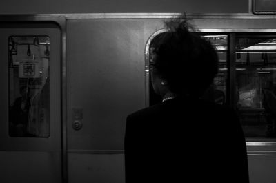 Rear view of woman looking at train
