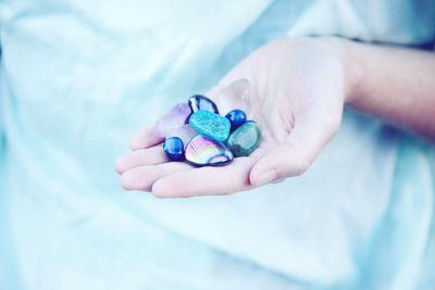 Cropped hand of woman holding crystals