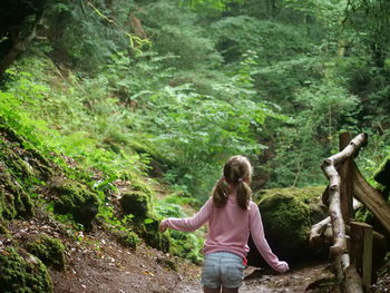 Rear view of woman in forest