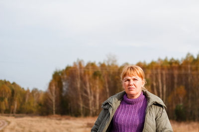 Portrait of woman standing against sky