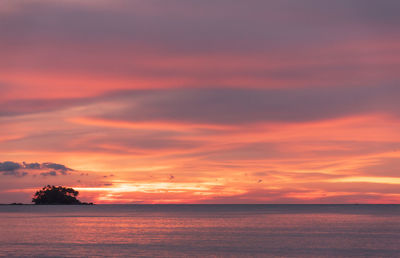 Scenic view of sea against romantic sky at sunset with a small island