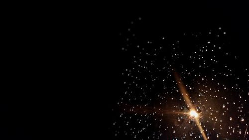 Close-up of water splashing against black background