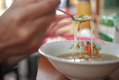 Close-up of hand holding bowl