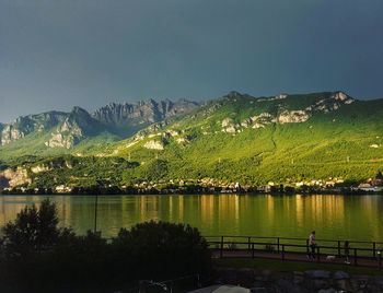 Scenic view of lake and mountains against clear sky