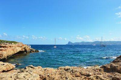 Scenic view of sea against clear blue sky