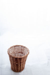 High angle view of empty whicker basket on white background