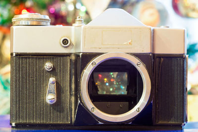Close-up of vintage camera against christmas tree