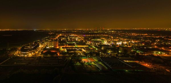 High angle view of illuminated buildings in city at night
