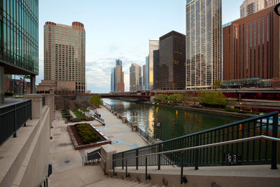 Canal amidst buildings in city against sky