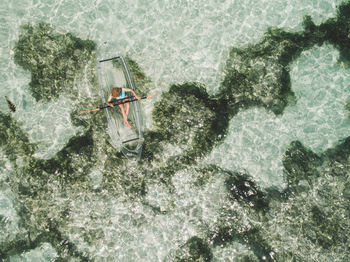 Directly above shot of woman on inflatable boat in sea