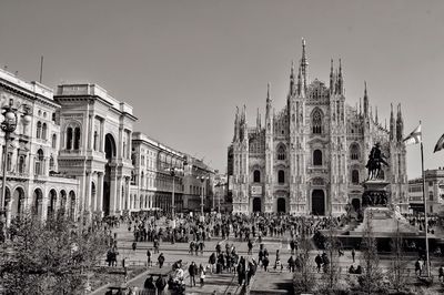 People in front of duomo di milano at piazza del duomo against sky