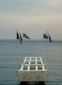 Flag on beach against sky