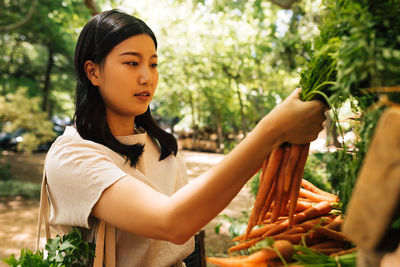 Portrait of young woman sitting on field