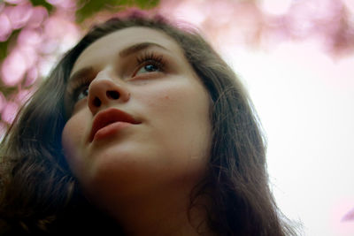 Close-up of young woman looking away outdoors