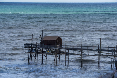 High angle view of hut on pier in sea