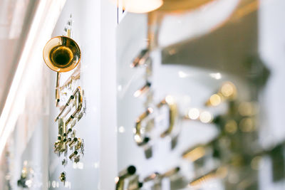 Low angle view of illuminated chandelier hanging on ceiling