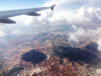Cropped image of airplane flying over landscape