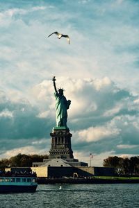 Low angle view of statue against cloudy sky