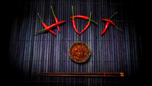 Close-up of red chili peppers on table