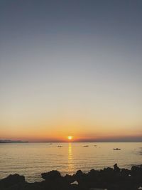 Scenic view of sea against clear sky during sunset