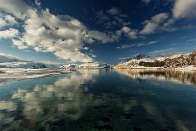 View of lake against mountain range during winter