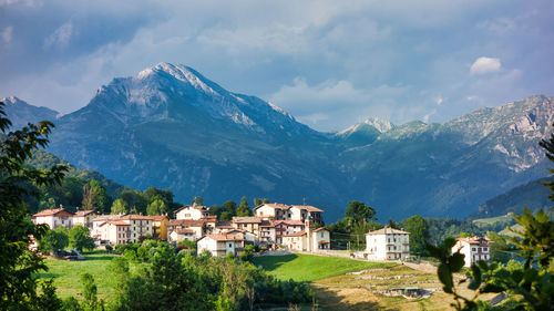 Townscape by mountain against sky