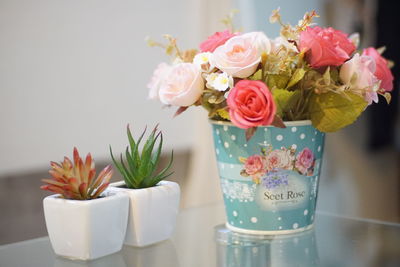 Close-up of pink roses in vase on table