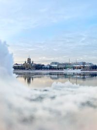 Reflection of building on water in city