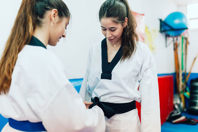 Young women wearing belt during taekwondo practice