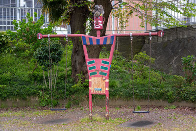Man with text on plant against trees