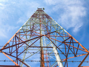 Low angle view of communications tower against sky